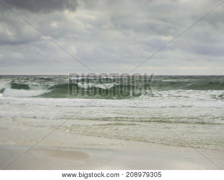 Artistic soft landscape of surf on Gulf Coast Beach on a stormy tropical day taken with tilt shift lens.
