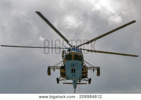 Tyumen Russia - August 4 2017: International Army Games. Engineering Formula contest. Military helicopter MI-8 with mine equipment in the cloudy sky