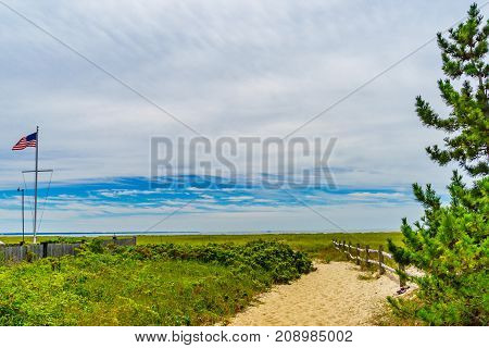Empty pathway with fence to the beach on a clear summer day in Provincetown, Cape Cod, Massachusetts USA