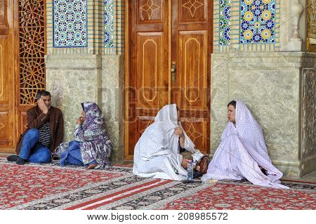 Fars Province Shiraz Iran - 19 april 2017: Shah Cheragh Shrine iran shrine shiraz shrine muslim pilgrims are sitting in the courtyard.