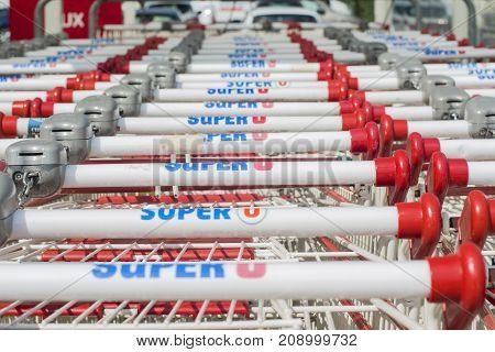 LE MANS FRANCE-JULY 25 2017: Row of many push cart of french mark Super U for shopping