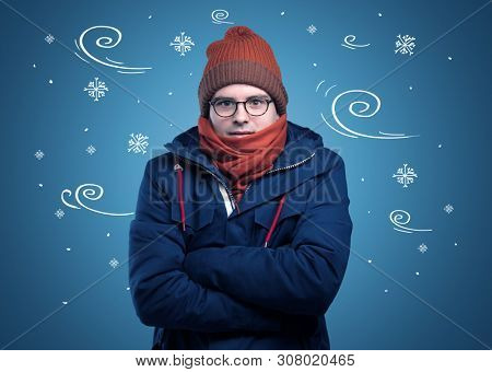 Young hipster frozen boy with doodled snowflakes and windy concept