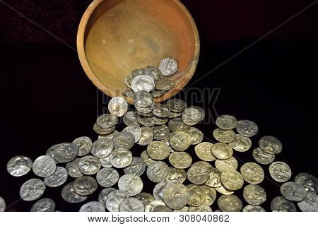 Silver Coins Poured Out Of A Clay Pot