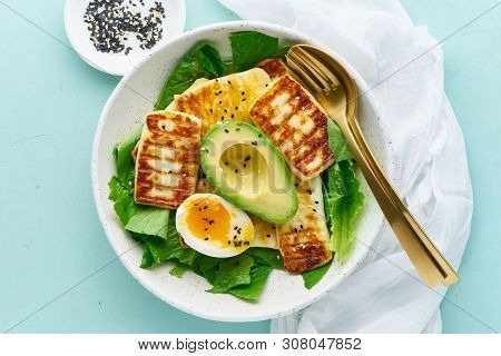 Keto Ketogenic Diet Soft Boiled Eggs With Grilled Haloumi, Avocado And Lettuce, Mediterranean Cuisin