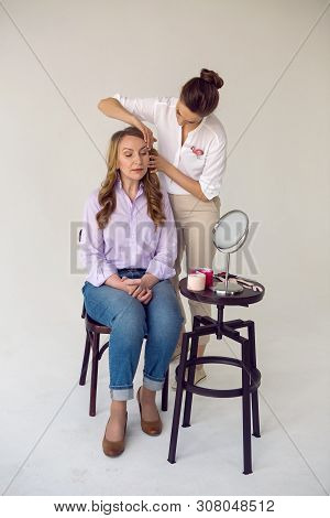 Beautician Aesthetician Glues Kinesio Tape On The Face