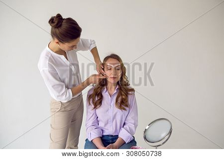 Beautician Aesthetician Glues Kinesio Tape On The Face