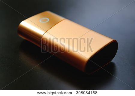 New Kind Of Electronic Cigarette. Iqos Tobacco Heating System. On A Black Background, A Close-up Of 