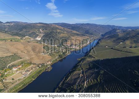 Scenic Aerial View Of The Douro Valley And River With Terraced Vineyards Near The Village Of Tua, Po