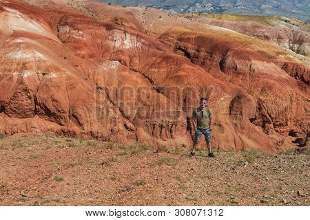 Relaxing man in Valley of Mars landscapes in the Altai Mountains, Kyzyl Chin, Siberia, Russia