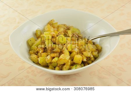 Yellow Summer Squash And Zucchini With Onion Side Dish In White Serving Bowl With Serving Spoon On T