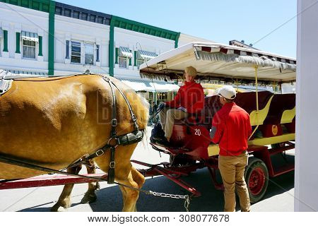 Mackinac Island, Michigan / United States - June 11, 2018: A Coachman For The Mackinac Island Carria