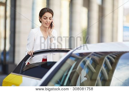 Waist Up Portrait Of Beautiful Businesswoman Opening Taxi Doorin Rush Hour In City Center, Copy Spac