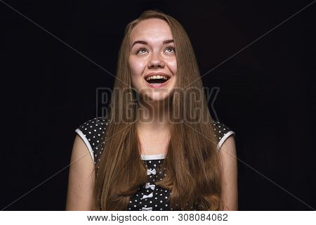 Close Up Portrait Of Young Woman Isolated On Black Studio Background. Photoshot Of Real Emotions Of 