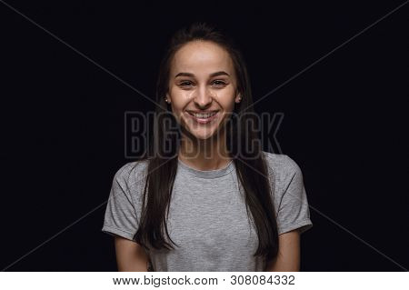 Close Up Portrait Of Young Woman Isolated On Black Studio Background. Photoshot Of Real Emotions Of 
