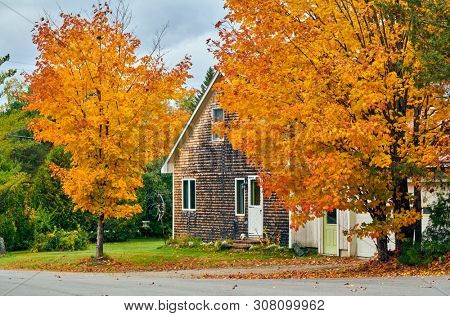 Driveway at suburban neighborhood. Autumn day in Maine, USA.