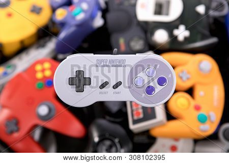 Taipei, Taiwan - June 19, 2019: A Nintendo Nes Mini System And Controller On Top Of A Pile Of Retro 