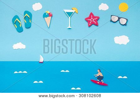 Creative Summer Background With Set Of Beach Accessories In The Sky Above Blue Sea With Serfer, Pano