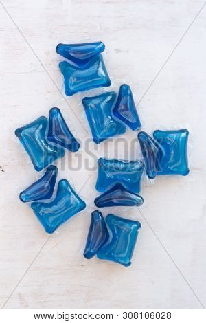 Set Of Blue Washing Detergent Capsule Isolated On White Wooden Background. Close-up.liquid Soap.