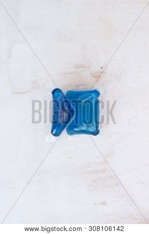 Set Of Blue Washing Detergent Capsule Isolated On White Wooden Background. Close-up.liquid Soap.