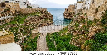 Polignano A Mare, Italy, May 4 , 2019 - Panoramic View Of Of Polignano A Mare Beach,  Town On The Ro