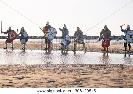 Slavic Warriors Reenactors With Wearpons And Shields Training Fighting Outdoors At Seaside