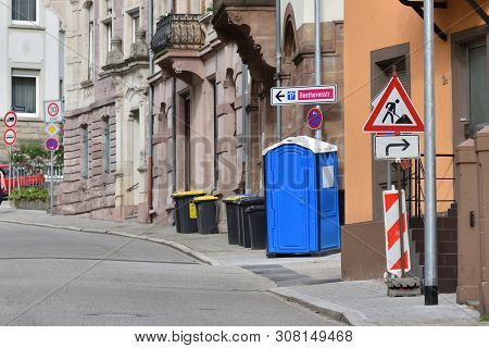 Blue Bio Toilet On A Street In Europe, Germany. Bio Toilet At The Time Of Repair Work On The Street