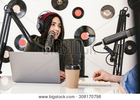 Two radio hosts moderating a live show for radio