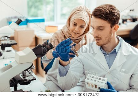 Handsome Bearded Man Looking At The Test Tube With Seeds