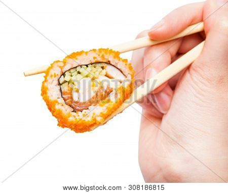 Female Hand With Disposable Chopsticks Holds California Ebi Sushi Roll Close Up Isolated On White Ba