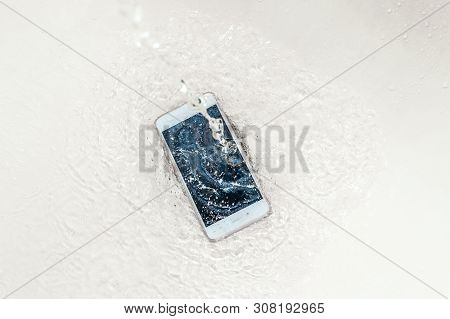 Phone In The Water. Concept Broken Phone. Smartphone Repair Concept