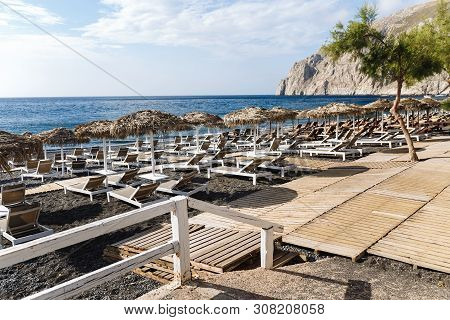 Kamari Beach, Santorini. Volcanic Sand Beach And Mountain Of Kamari Beach, Santorini, Greece
