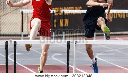 Two High School Boys Are Tied In The 400 Meter Hurdle Race Entering The Final Straightway.