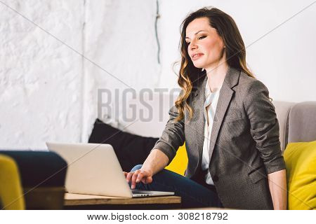 Concentrated At Work. Confident Young Adult Middle-aged Woman In Smart Casual Clothes, Working On A 
