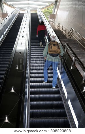 escalator. moving stairs going up and down for ease of pedestrian traffic.  
