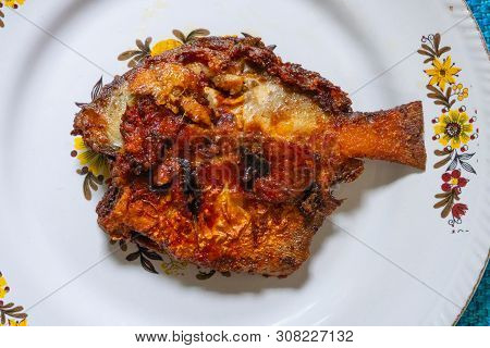 A Fried Pomfret Fish Served On A White Decorated Platter, Spicy Indian Food. Pomfrets Are Perciform 