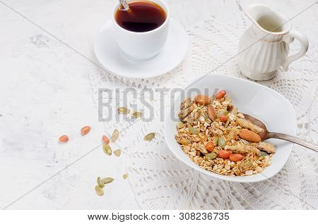 Granola From Several Types Of Cereals With Nuts,coconut Chips And Dried Fruits  In White Plate For B