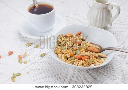Granola From Several Types Of Cereals With Nuts,coconut Chips And Dried Fruits  In White Plate For B
