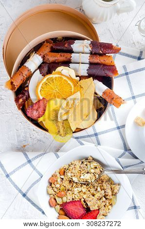 Granola From Several Types Of Cereals With Nuts,coconut Chips And Dried Fruits  In White Plate For B