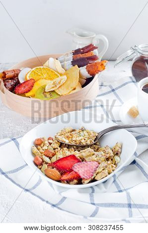 Granola From Several Types Of Cereals With Nuts,coconut Chips And Dried Fruits  In White Plate For B