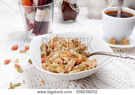 Granola From Several Types Of Cereals With Nuts,coconut Chips And Dried Fruits  In White Plate For B