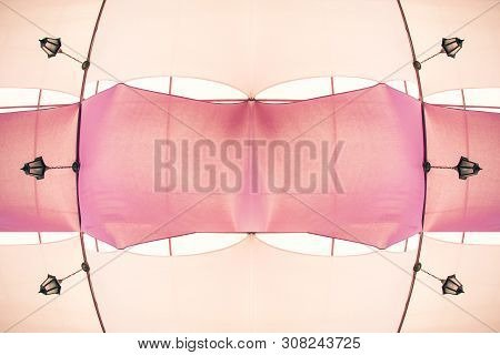 Part Of Cafe Interior. Ceiling Made Of Six Lamps And Pink And Beige Colored Silk Textile, Looks Like