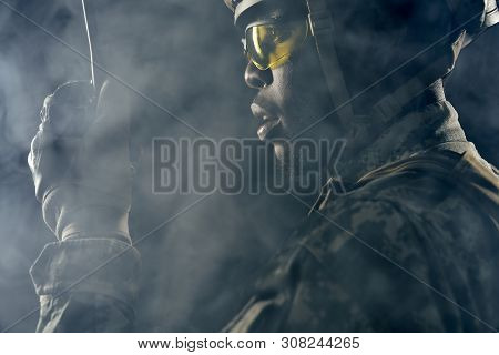 American Soldier Wearing Yellow Glasses And Helmet Listening Answers From Remote Radio Communication