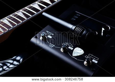 Multieffects Processor For Electric Guitar And A Microphone On Black Background. Close Up.