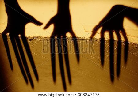 Strange Shadow On The Wall.terrible Shadow. Abstract Background. Black Shadow Of A Big Hand On The W
