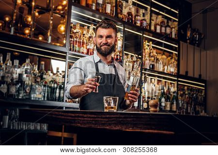Cheerful Barman Is Making Beverage For Customers At Cozy Restauraunt.