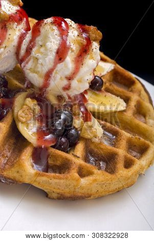 Gofre - Belgian Homemade Waffles With Ice Cream, Bananas And Nuts On A White Plate