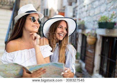 Smiling Gorup Of Friends With Map. Tourism, Travel, Leisure, Holidays And Friendship Concept