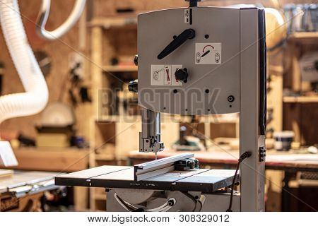 detail of carpenter tool bandsaw in workshop