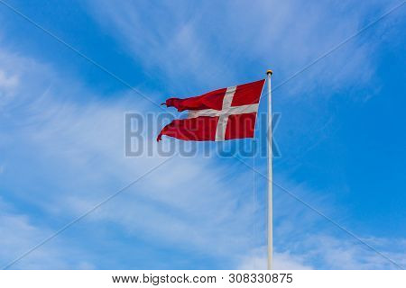 Danish Flag On Blue Sky Summer Time