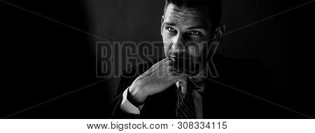 Black And White Tone Banner Of Interrogator In Shadow With Serious Face Thinking And Staring At Crim